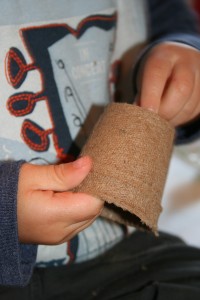 Little boy holding seed pots