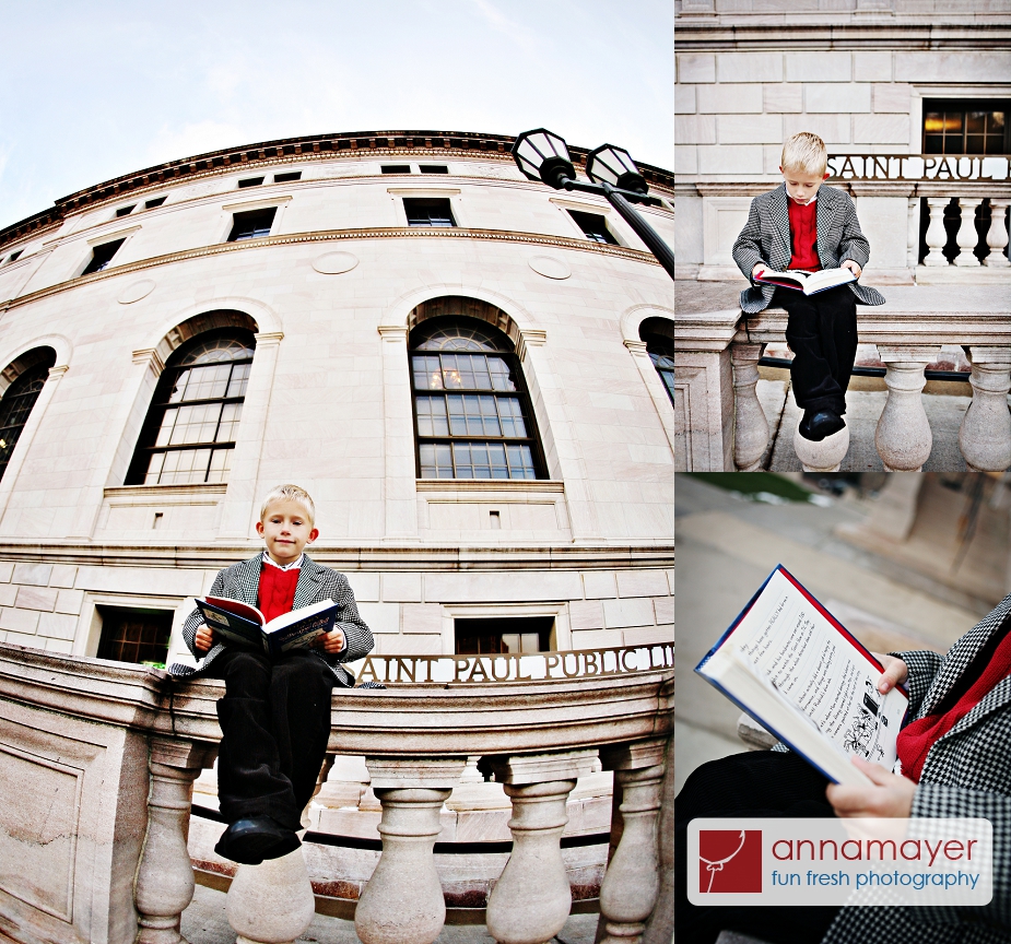 A boy reading a book outside Central Library in Rice Park, downtown Saint Paul