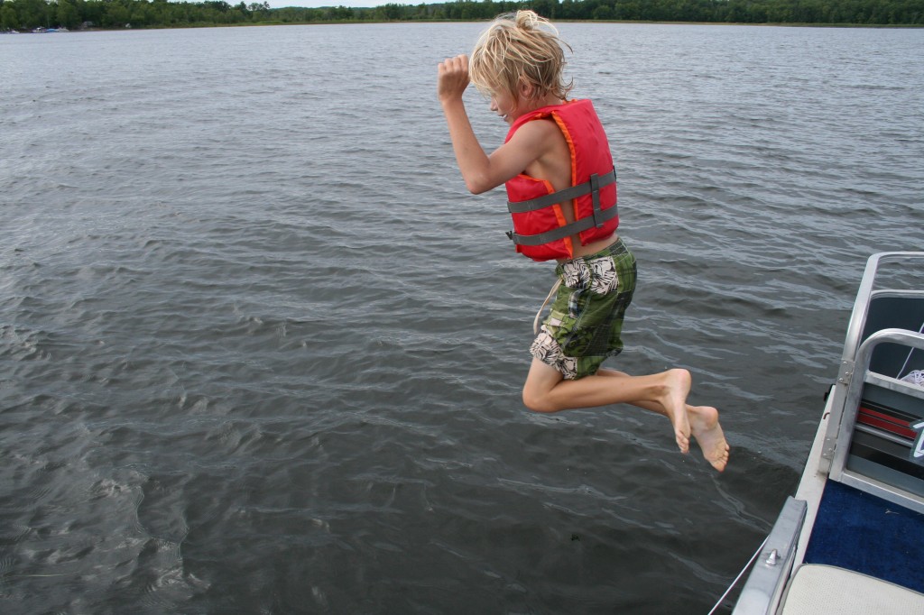 Boy jumping into the lake